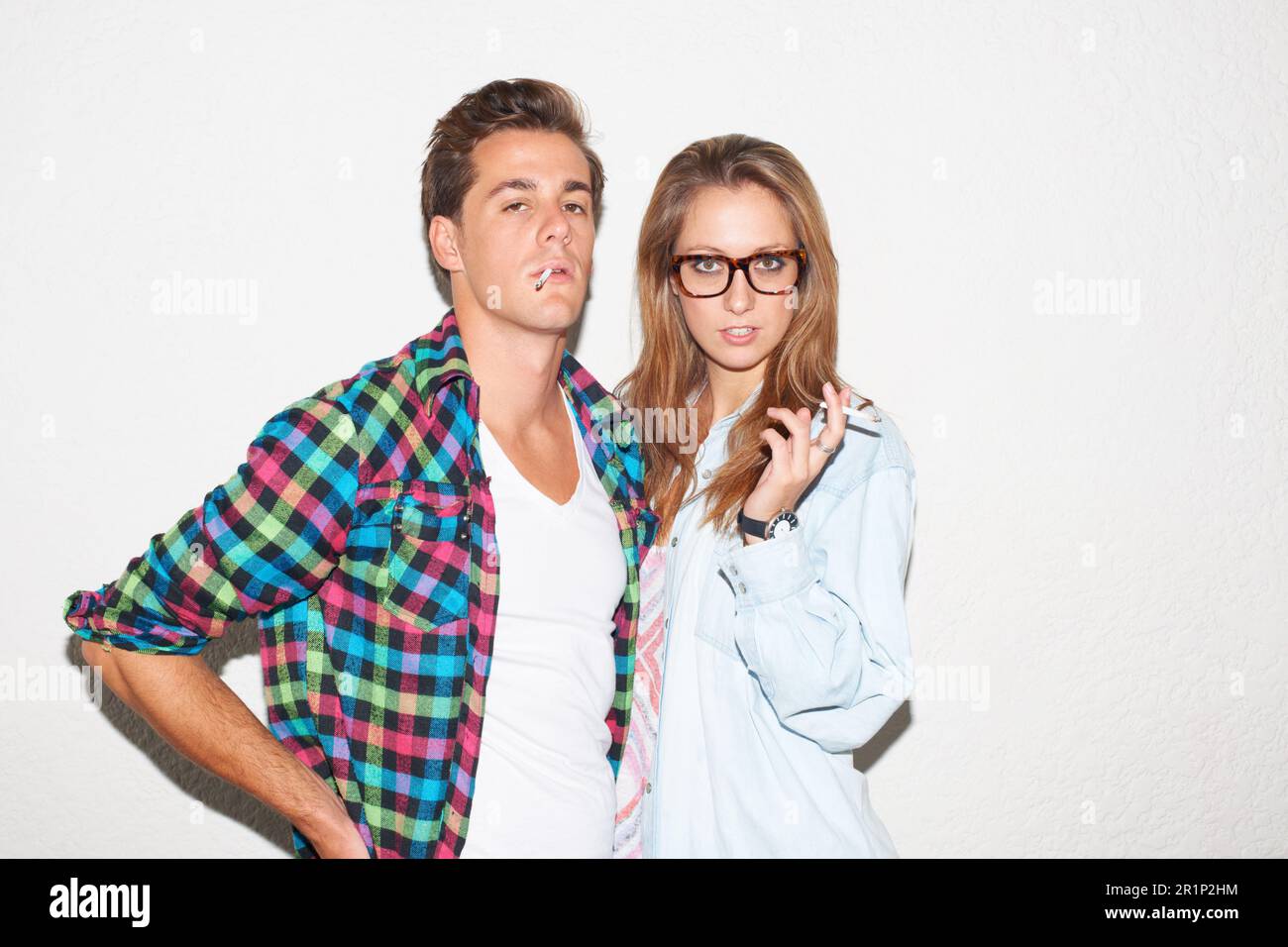 Party portrait of hipster couple smoking with glasses, gen z fashion