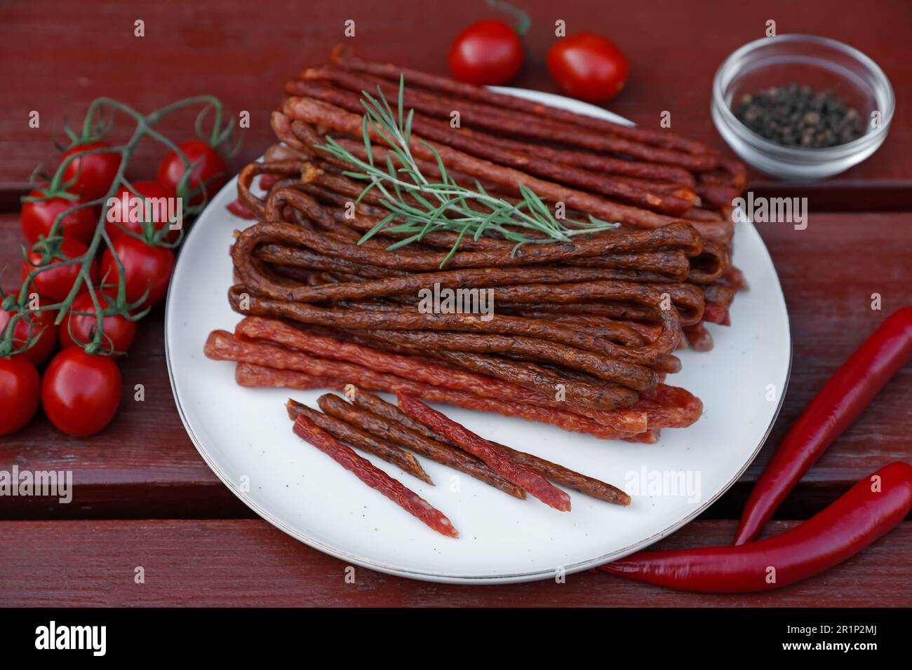 Tasty Dry Cured Sausages kabanosy And Ingredients On Wooden Table tasty-dry-cured-sausages-kabanosy-and-ingredients-on-wooden-table