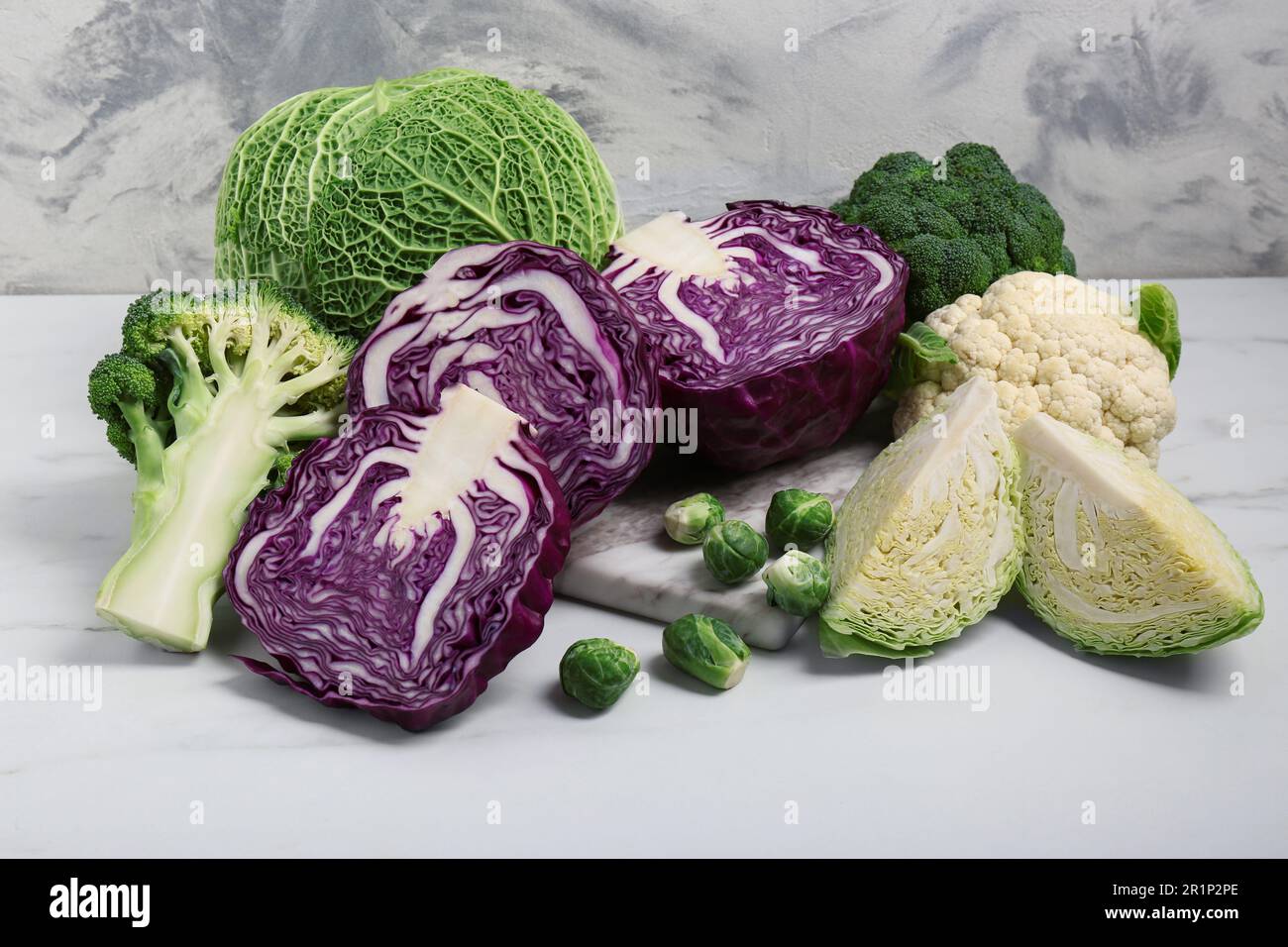 Many different types of cabbage on white marble table Stock Photo