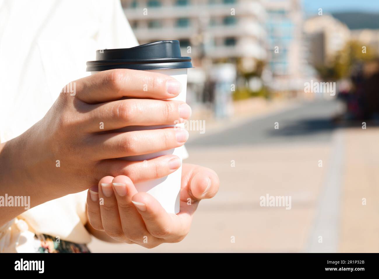 Close-up of Male Hands Holding a Paper Coffee Cup and Holder for