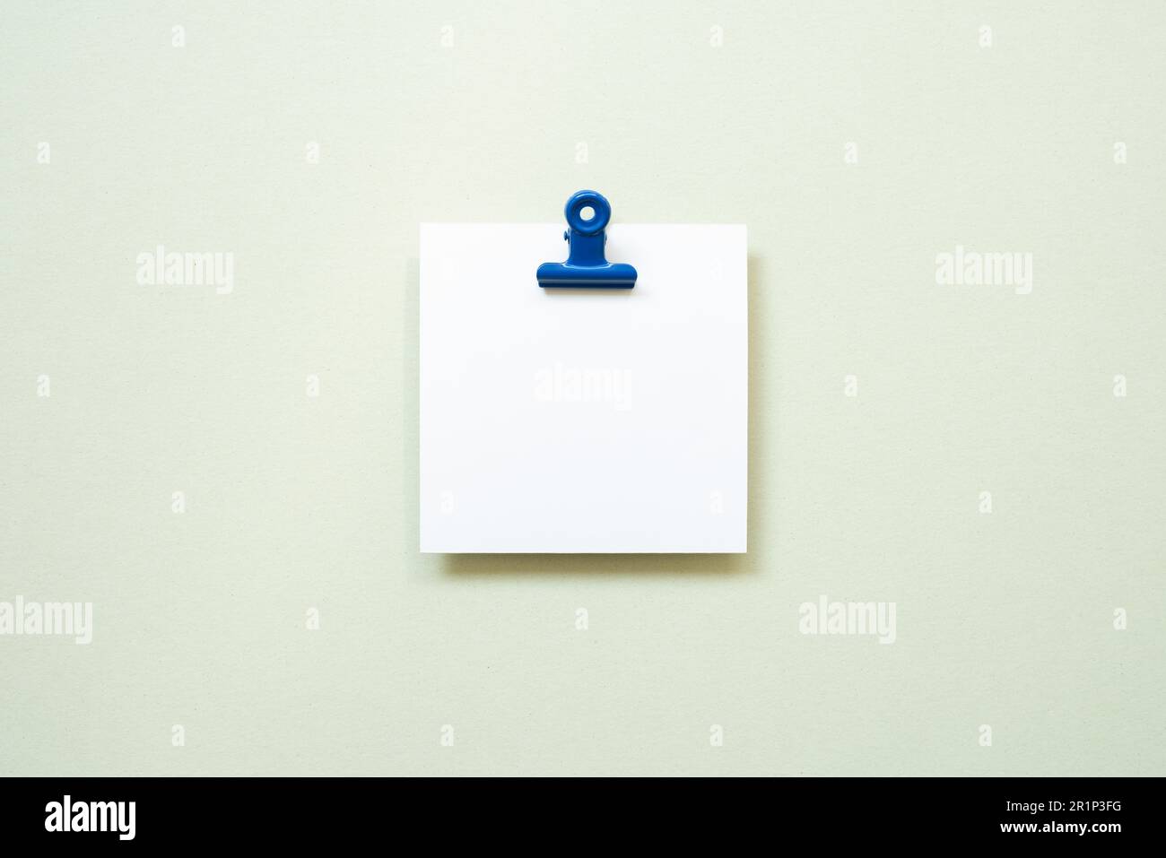 White blank memo pad with clip on mint background. top view, copy space Stock Photo