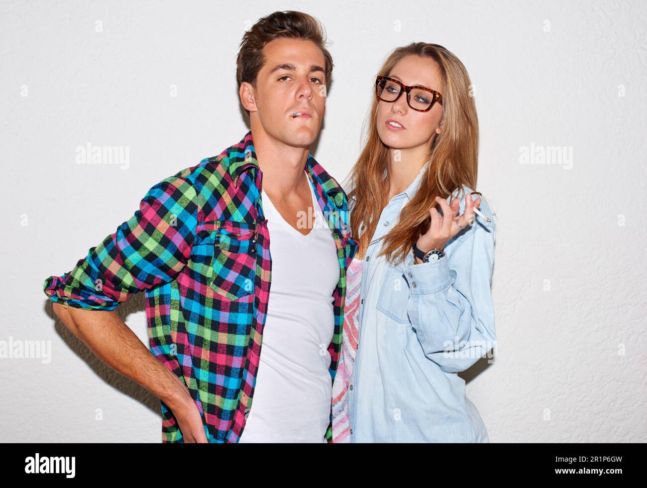 Smoking, tobacco and portrait of hipster couple with white wall