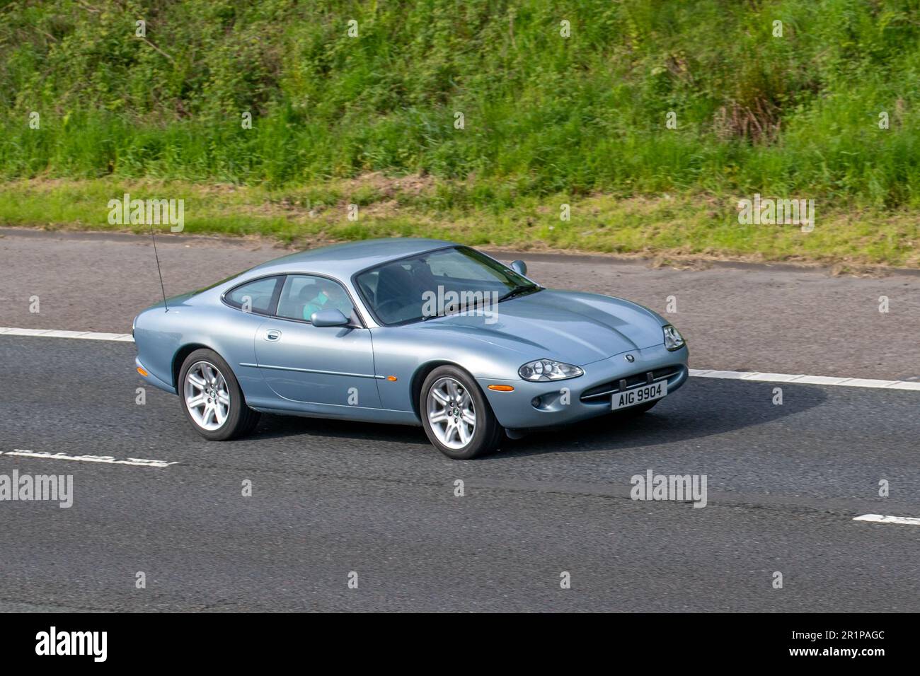 1996 60s sixties Jaguar Xk8 Coupe Auto V8 Auto Silver Car Coupe Petrol  3980 cc two door sports car; travelling on the M61 motorway, UK Stock Photo