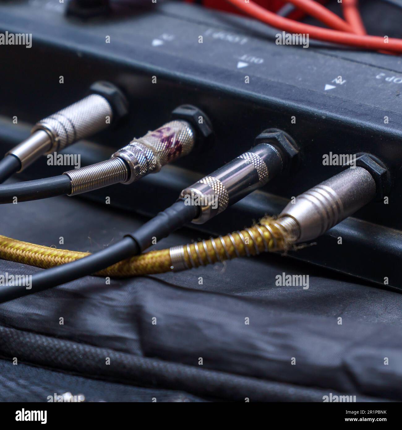 Audio jacks are plugged into a guitar synthesizer or processor Stock