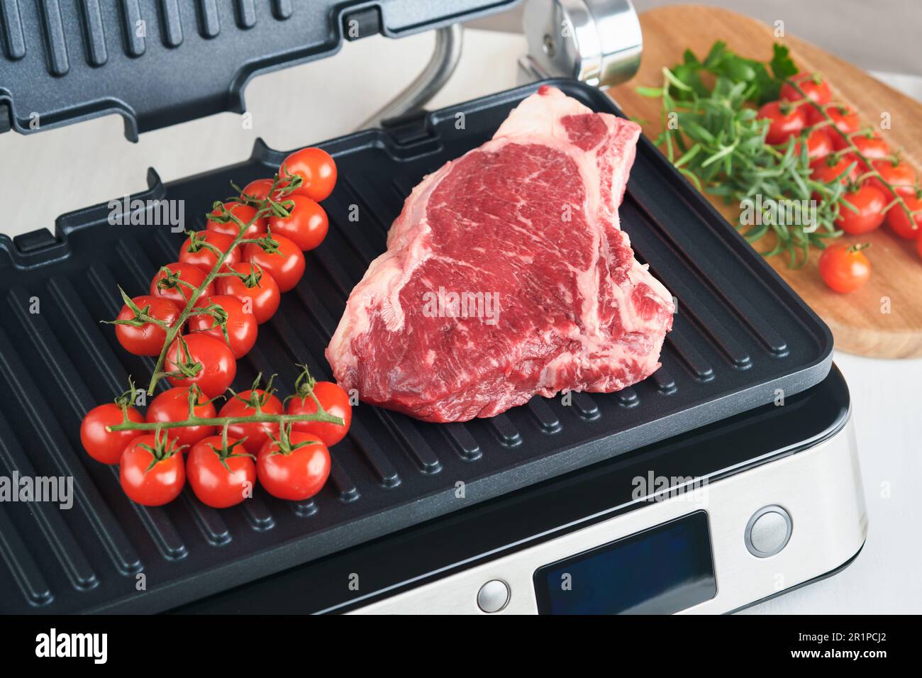Raw prime steaks on electric grill. Black angus prime meat steaks