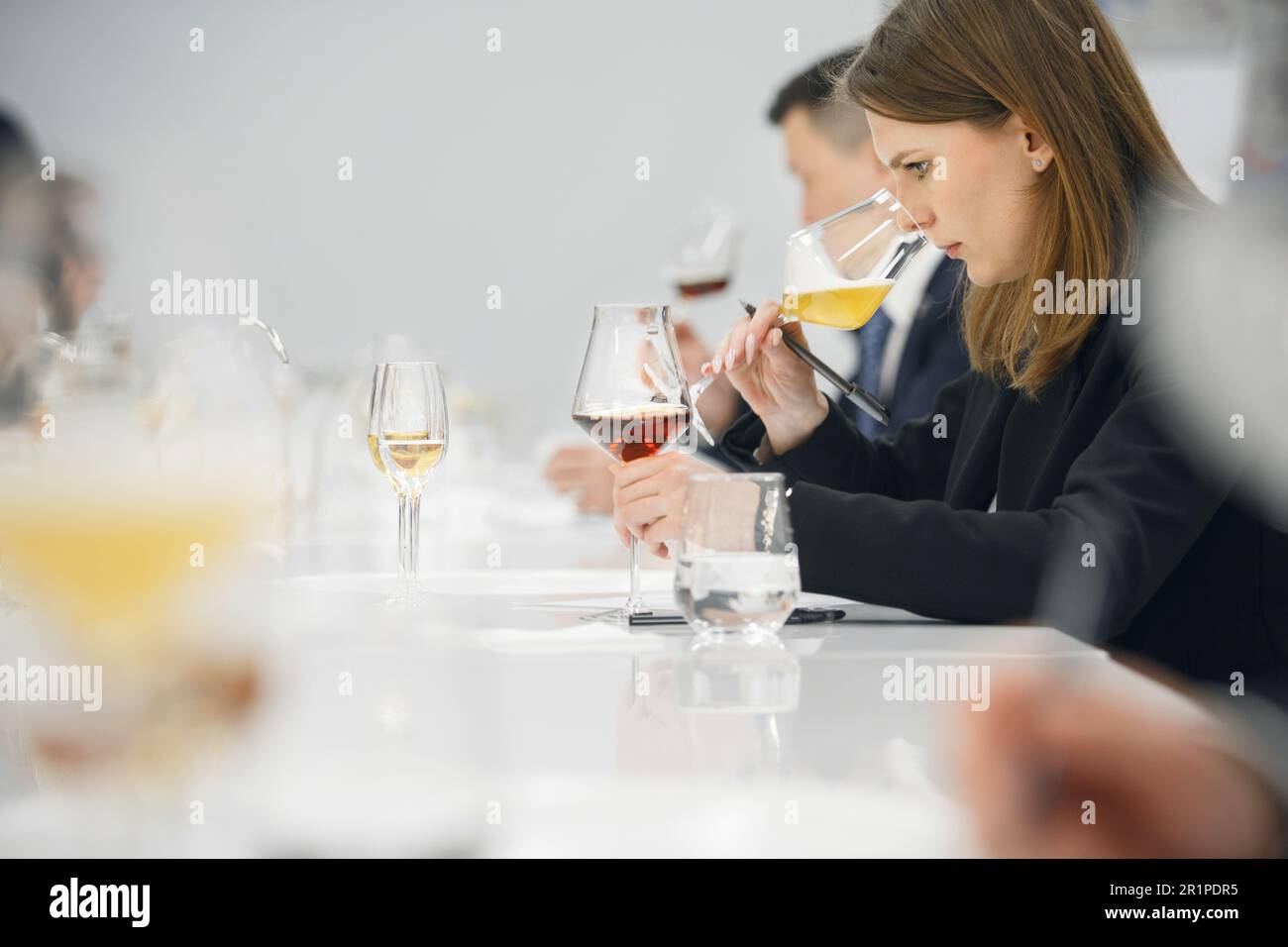 Wine waiter woman during blind tasting various alcoholic beverages