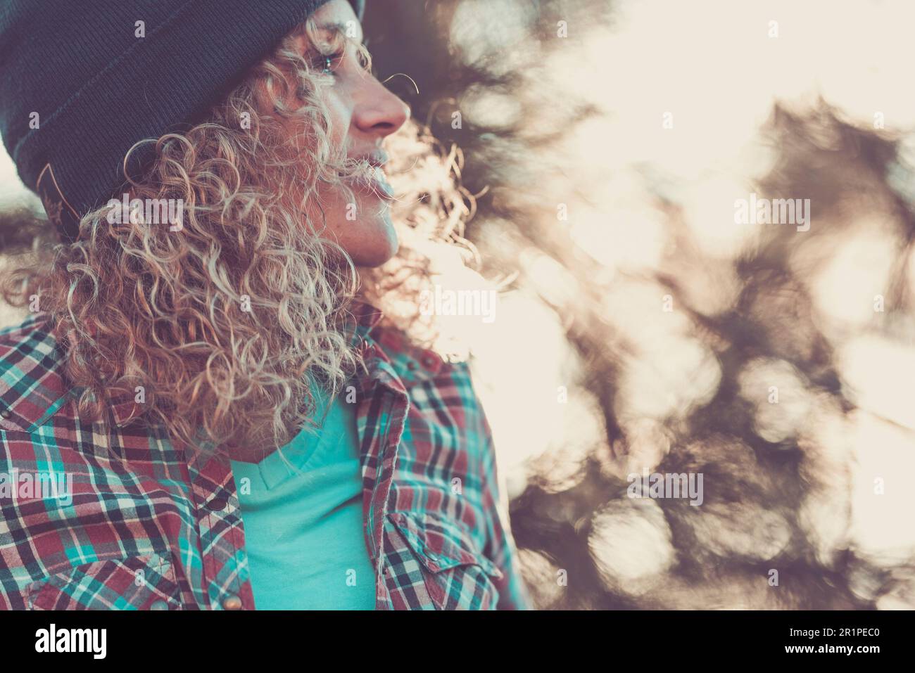 woman, blonde, curls, cap, check shirt, profile, detail, sunny, blur