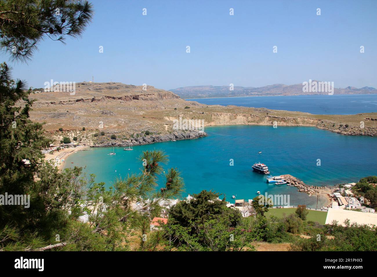 View from the Acropolis to the harbor, Lindos Bay, sea, seashore, Lindos, Rhodes, Dodecanese, Greece, grasses, atmospheric, blue sky Stock Photo