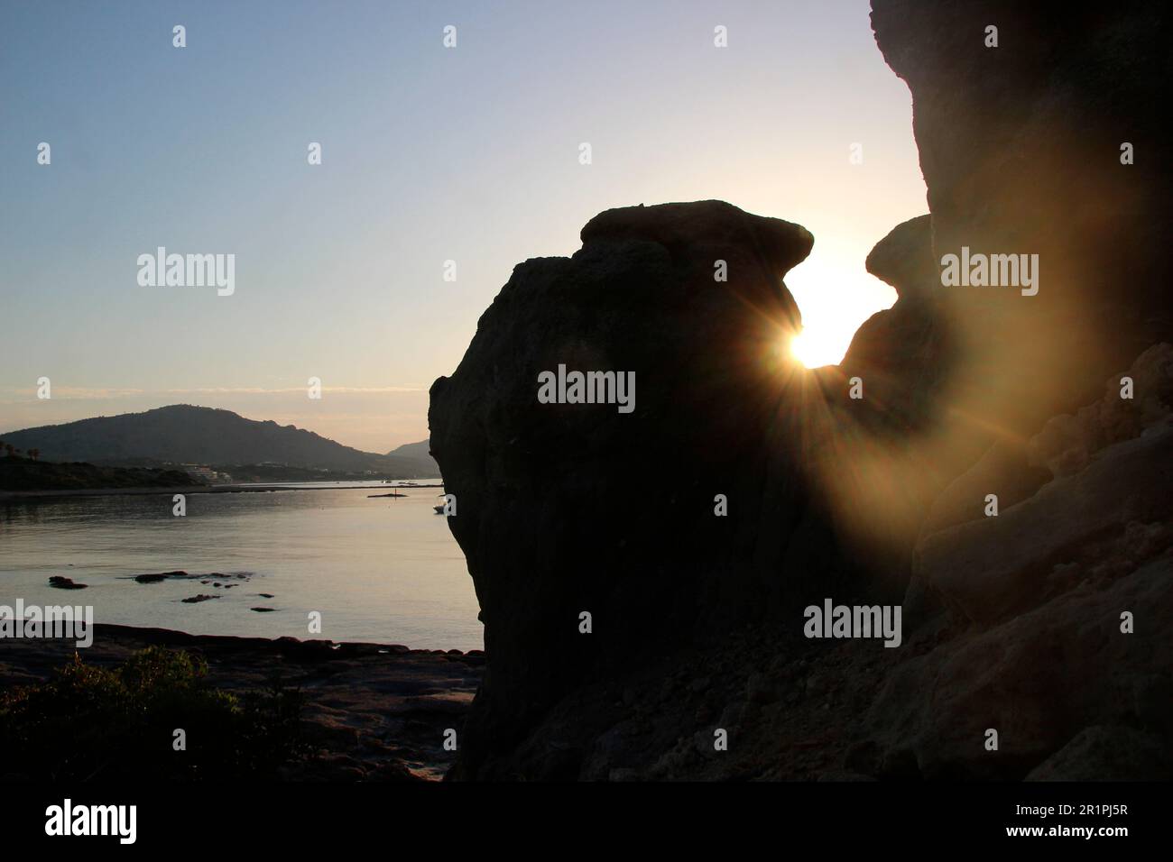 Sunrise on the beach near Kiotari, backlit rock, backlight shot, Rhodes, Greece Stock Photo