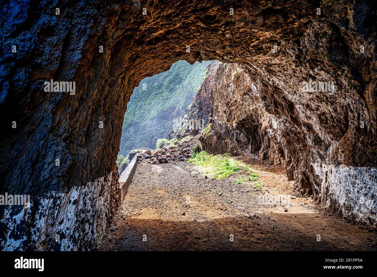 An imposing cave in the rugged mountainscape Stock Photo
