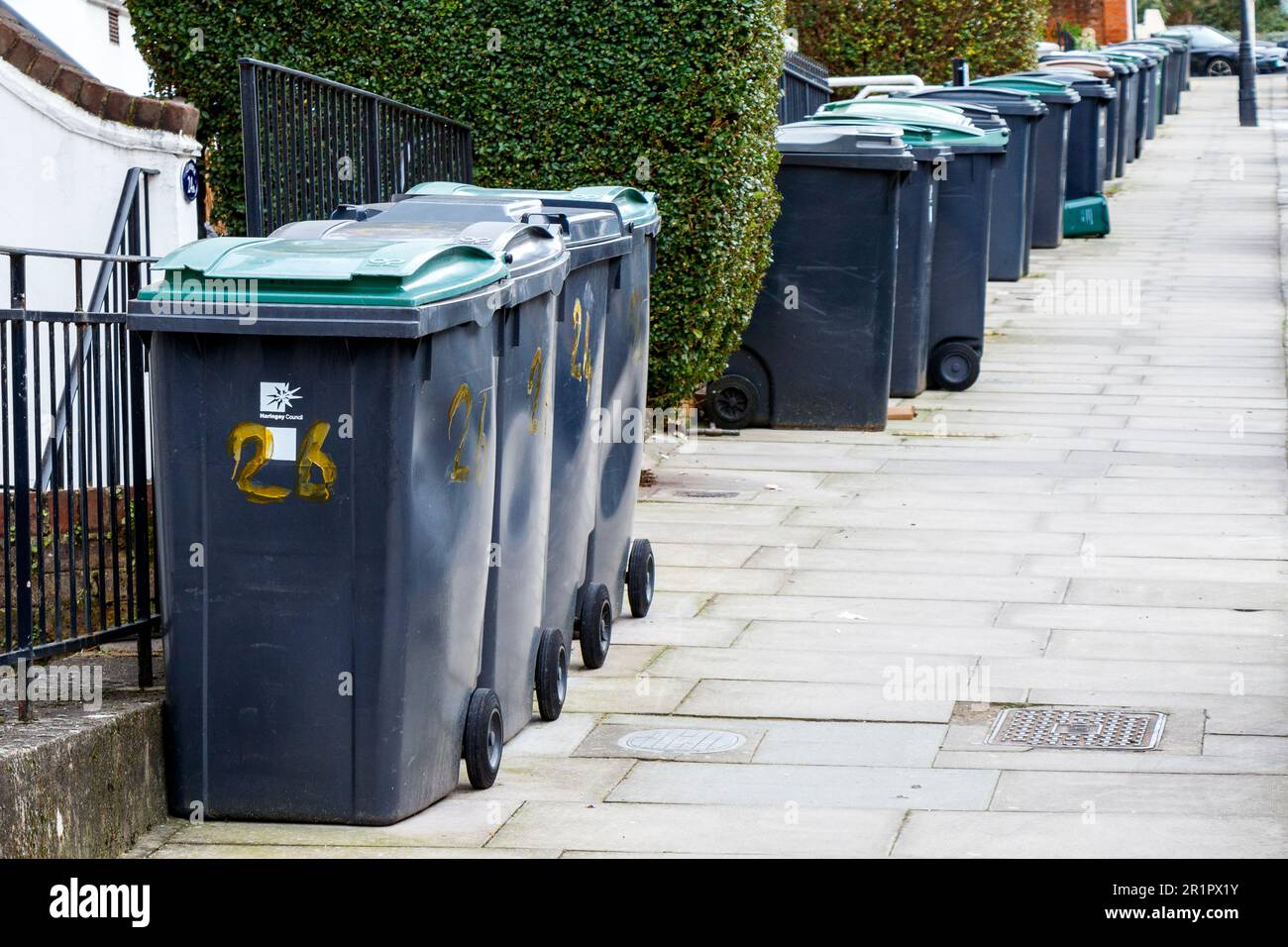 Plastic wheelie bins line a residential street in Haringey, North London, UK Stock Photo