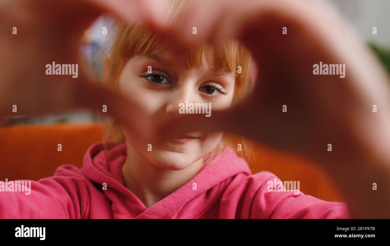 I love you. Child kid girl makes symbol of love, showing heart sign to ...