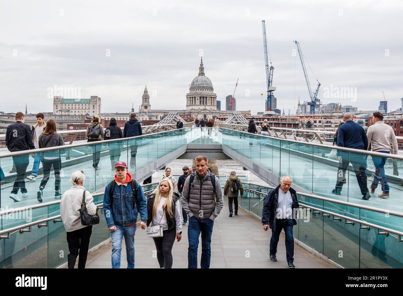 Pedestrians on the Millennium Bridge, St Paul's Cathedral in the background, London, UK Stock Photo