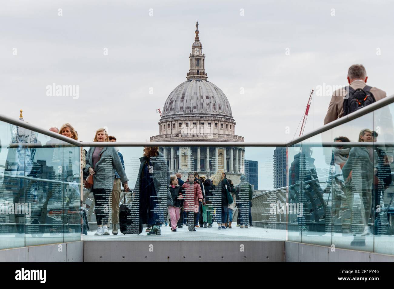 Pedestrians on the Millennium Bridge, St Paul's Cathedral in the background, London, UK Stock Photo
