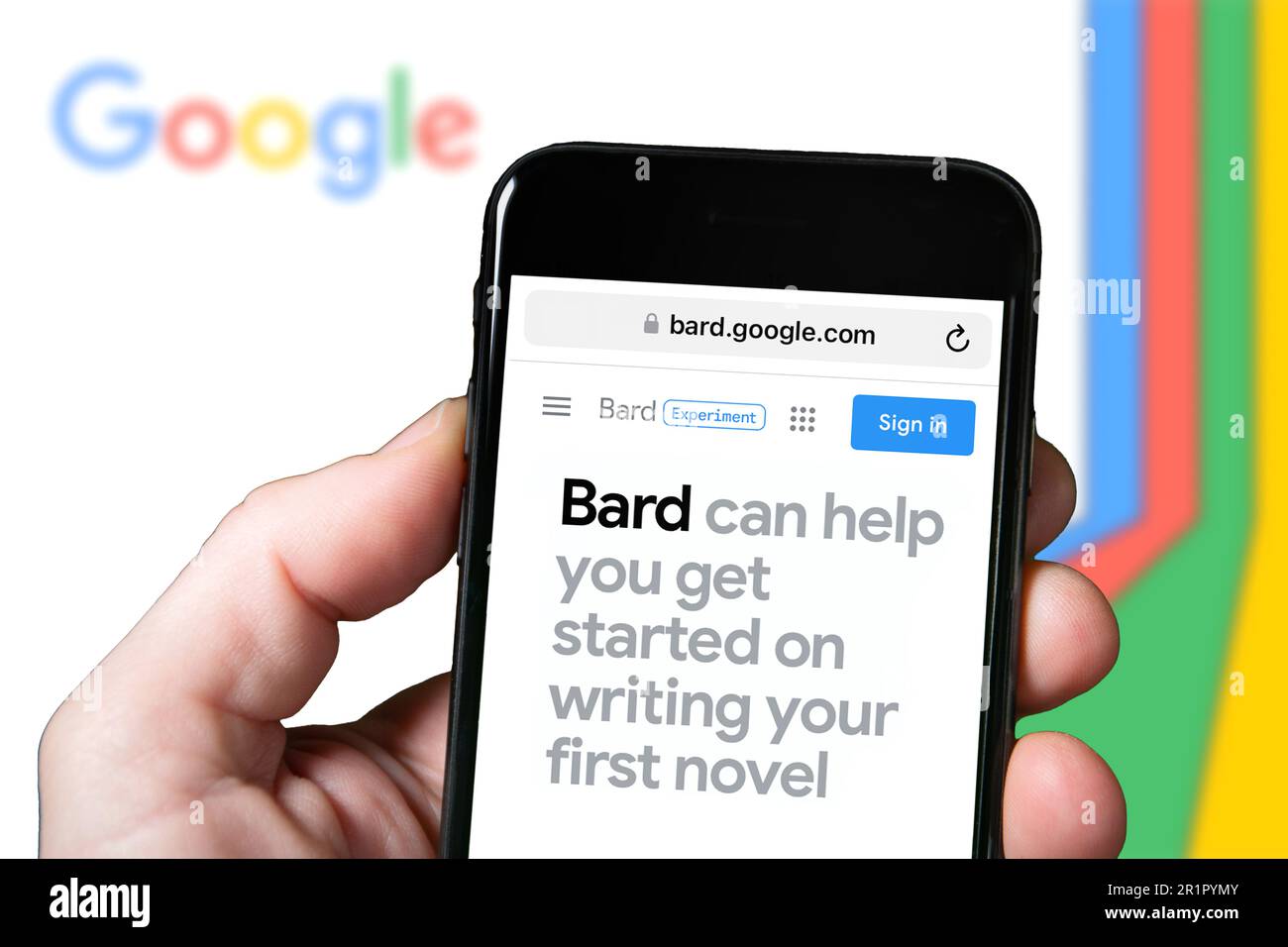 Goggle Bard AI chatbot website homepage. A person with smartphone using
