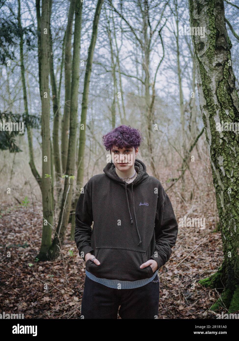 Non-binary person in forest Stock Photo