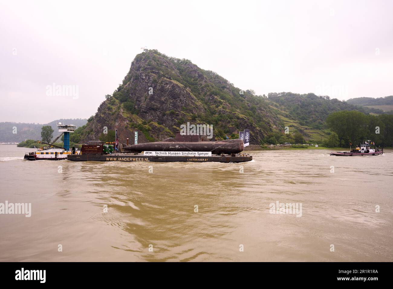 St. Goar, Germany. 15th May, 2023. The U17 submarine decommissioned by the Navy passes the Loreley rock. On May 17, the 48-meter-long boat is scheduled to land in Speyer and be transported by road to the Technik Museum. Later, it will be on permanent display in Sinsheim (Baden-Württemberg). Credit: Thomas Frey/dpa/Alamy Live News Stock Photo