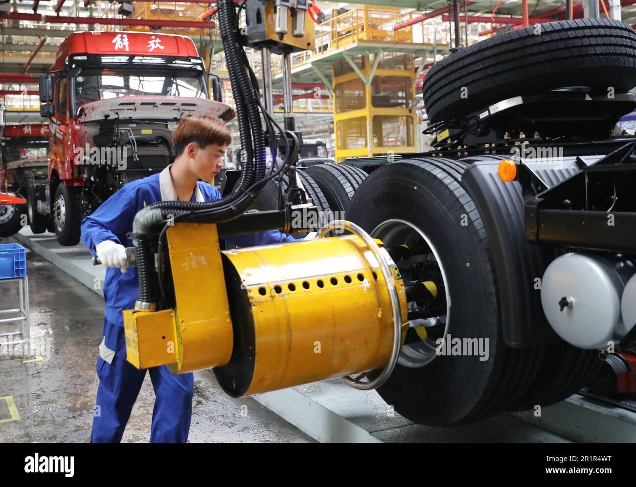 QINGDAO, CHINA - MAY 15, 2023 - Workers assemble vehicles at the final assembly workshop of an auto company in Qingdao, East China's Shandong province Stock Photo