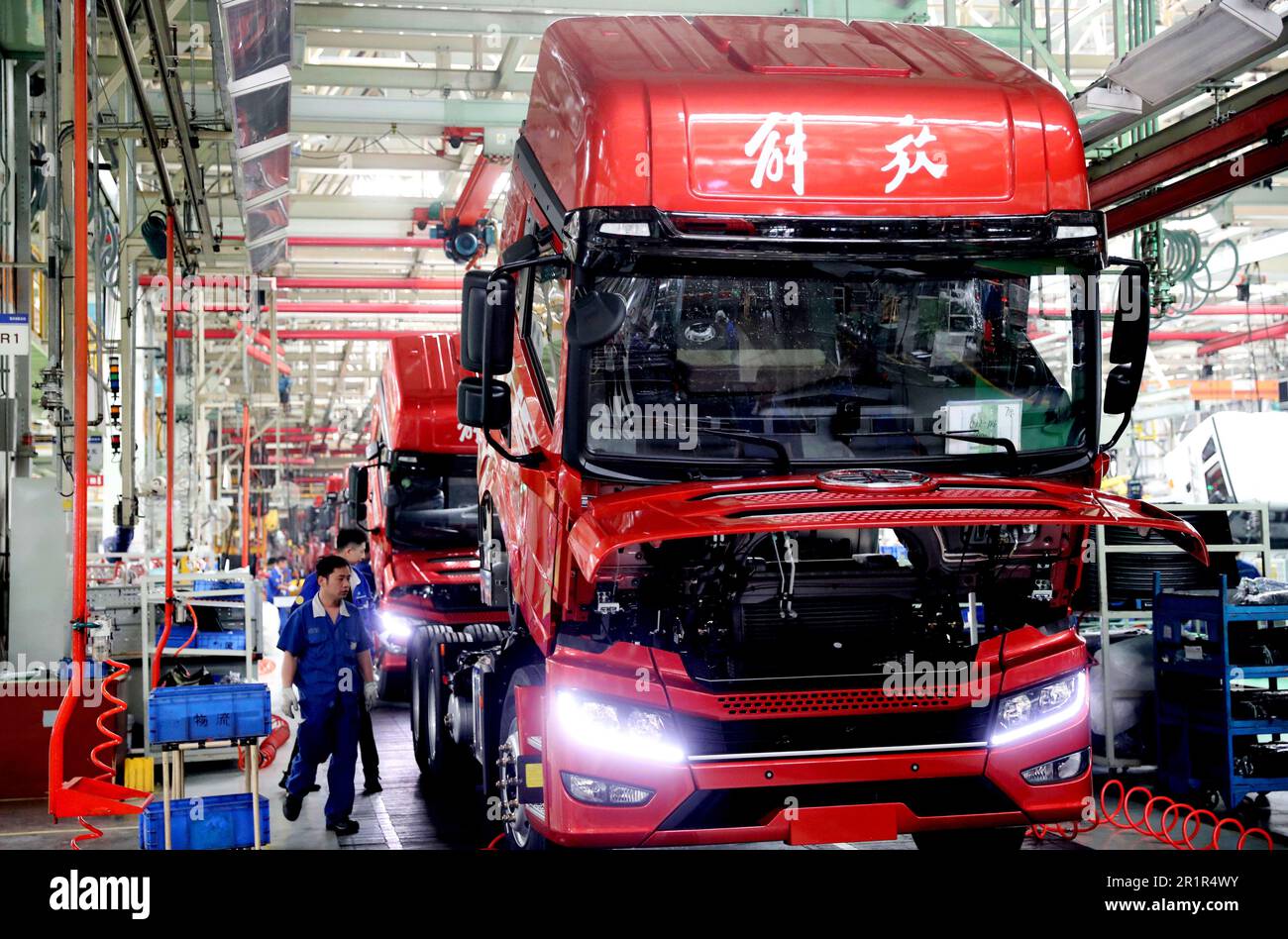 QINGDAO, CHINA - MAY 15, 2023 - Workers assemble vehicles at the final assembly workshop of an auto company in Qingdao, East China's Shandong province Stock Photo
