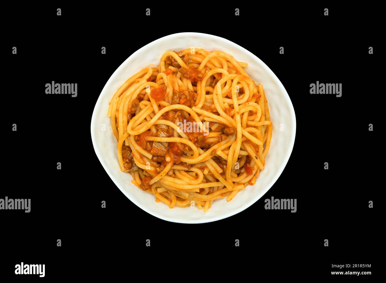 Classic italian bolognese sauce with pasta. Preparing lasagna. Making sauce. Italian food with noodles in plate isolated on black background. Meat ste Stock Photo
