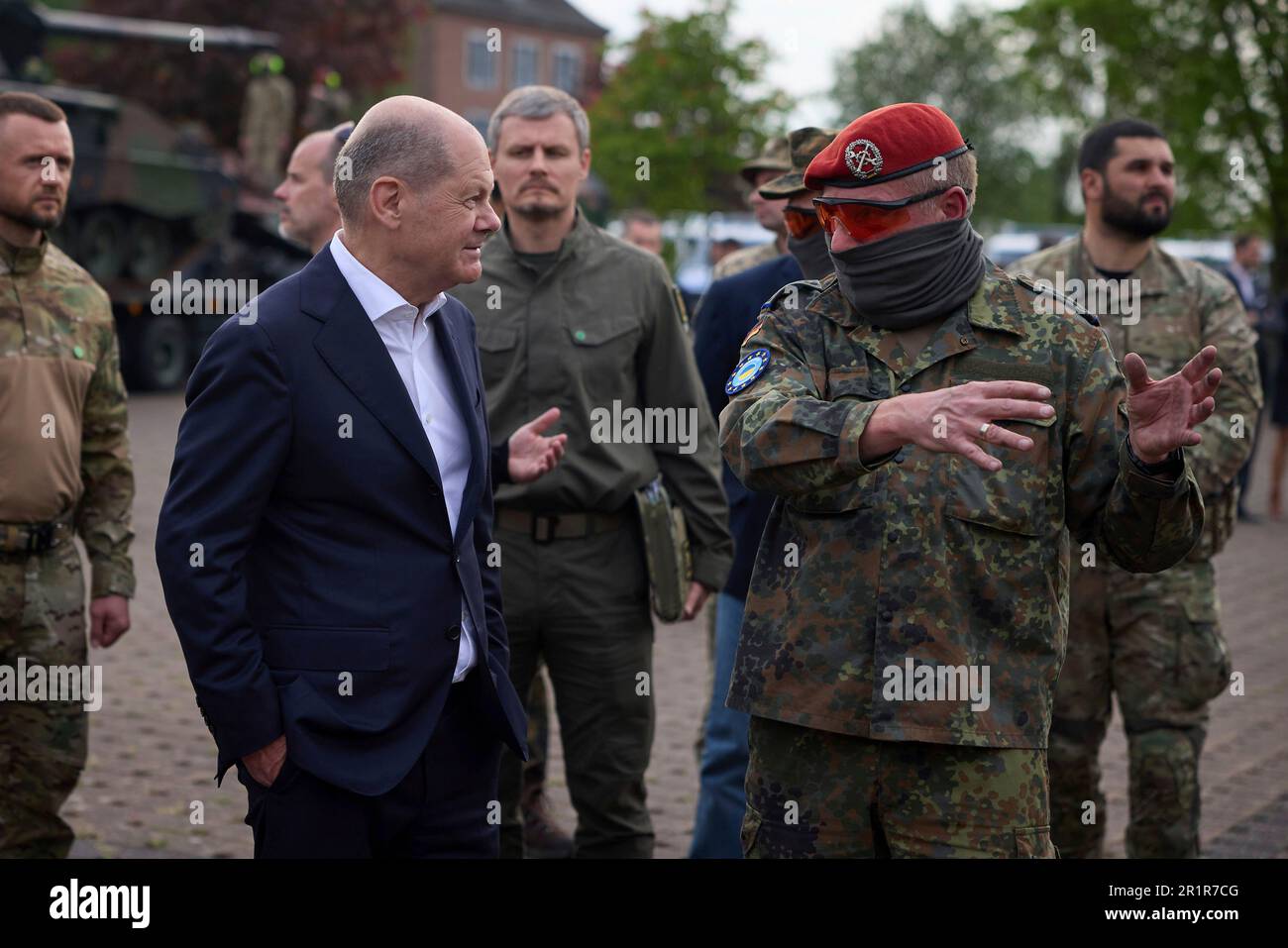 Aachen, Germany. 14th May, 2023. German Chancellor Olaf Schotz, left, speaks with a Ukrainian soldier during a visit with President Volodymyr Zelenskyy to Camp Aachen, May 14, 2023 in Aachen, Germany. The Germany Army is training Ukrainian soldiers on military hardware provided by Germany at the base. Credit: Pool Photo/Ukrainian Presidential Press Office/Alamy Live News Stock Photo