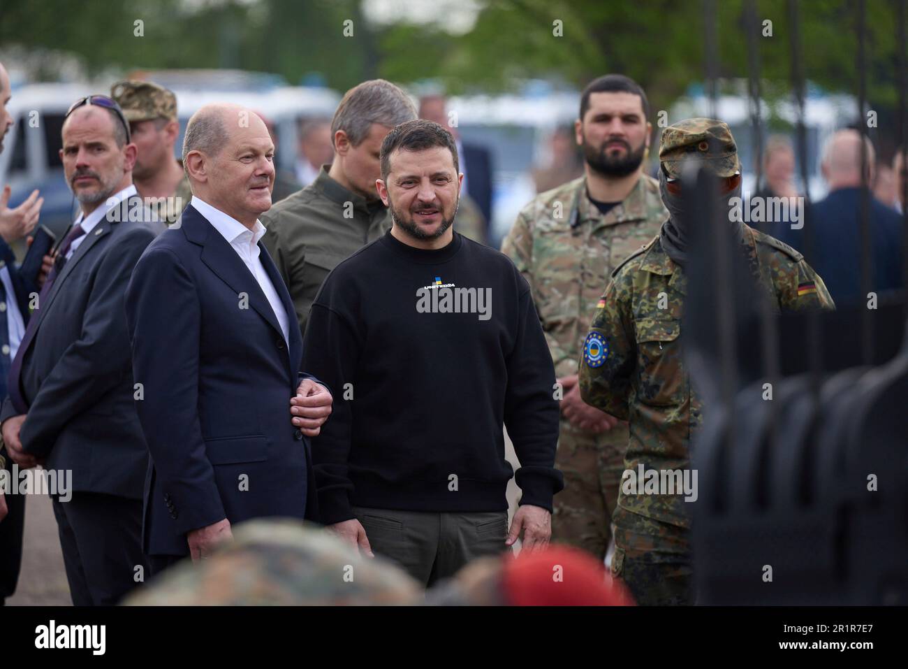 Aachen, Germany. 14th May, 2023. German Chancellor Olaf Schotz, left, and Ukrainian President Volodymyr Zelenskyy, center, watch a demonstration during a visit to Camp Aachen, May 14, 2023 in Aachen, Germany. The Germany Army is training Ukrainian soldiers on military hardware provided by Germany at the base. Credit: Pool Photo/Ukrainian Presidential Press Office/Alamy Live News Stock Photo
