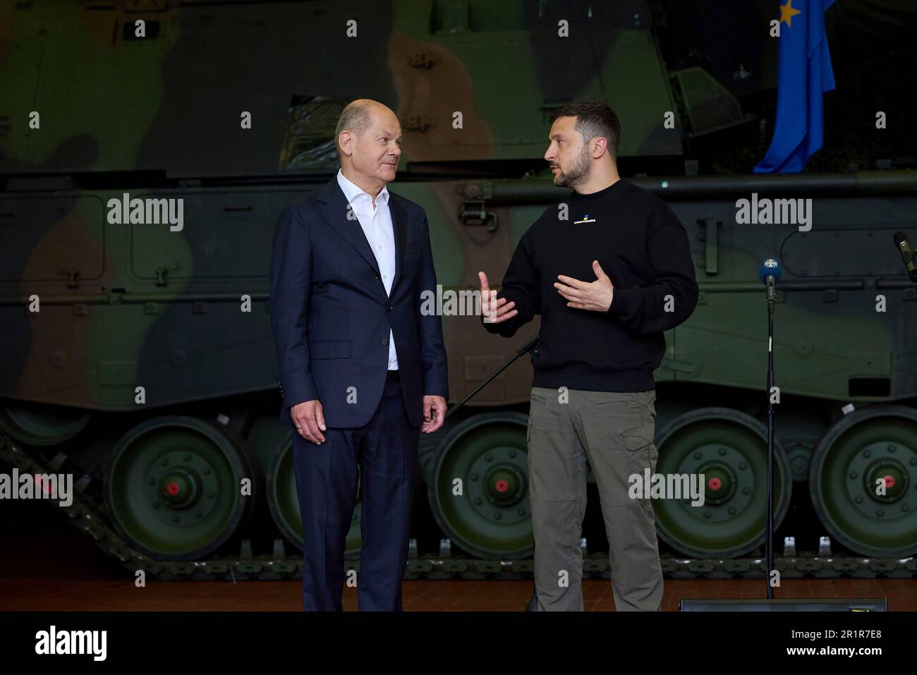 Aachen, Germany. 14th May, 2023. German Chancellor Olaf Schotz, left, listens to Ukrainian President Volodymyr Zelenskyy, right, during visit to Camp Aachen, May 14, 2023 in Aachen, Germany. The Germany Army is training Ukrainian soldiers on military hardware provided by Germany at the base. Credit: Pool Photo/Ukrainian Presidential Press Office/Alamy Live News Stock Photo