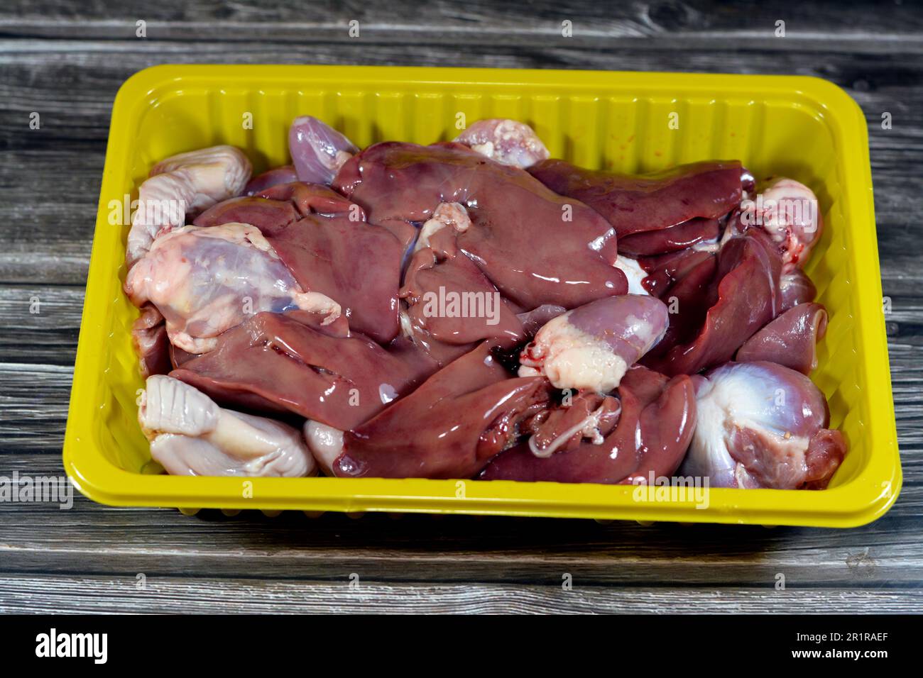 Raw chicken livers, gizzards and hearts, selective focus of fresh liver