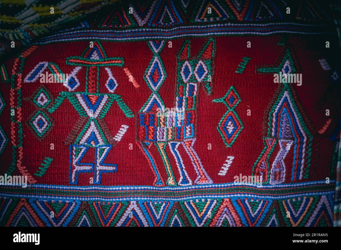 A vibrant, multi-hued rug with intricate geometric shapes and designs Stock Photo