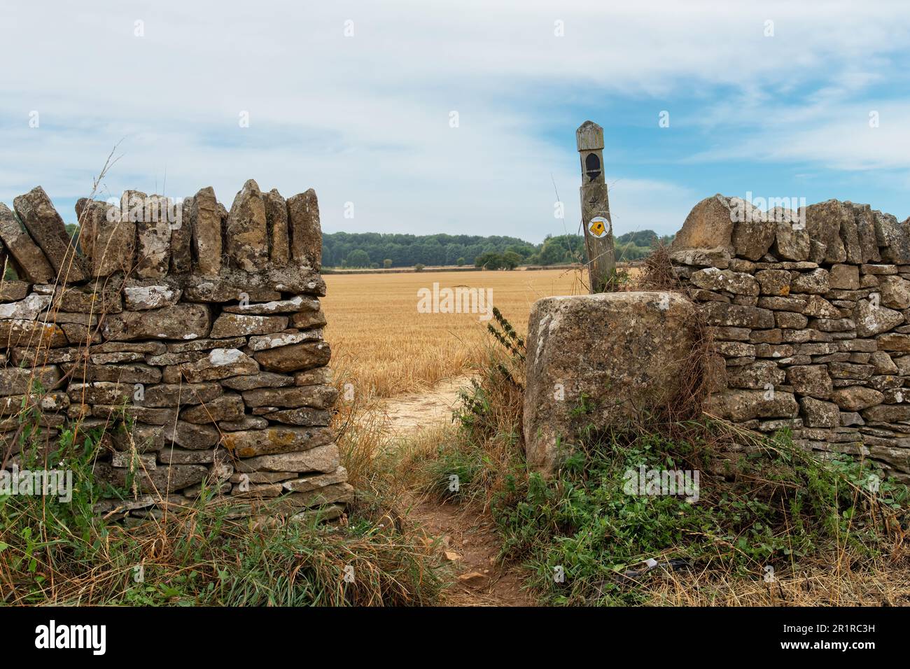 Broadway, UKAugust 2022; Close up view of opening in limestone drystone wall and signage of