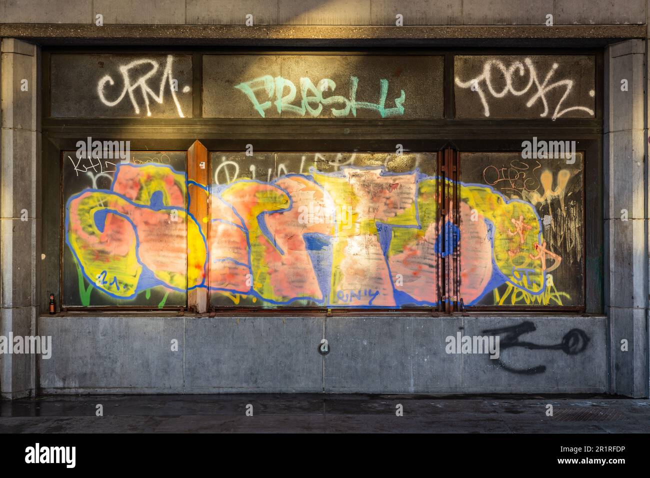 Multicolored graffiti illuminated by reflection by the first rays of the sun. Brussels. Stock Photo