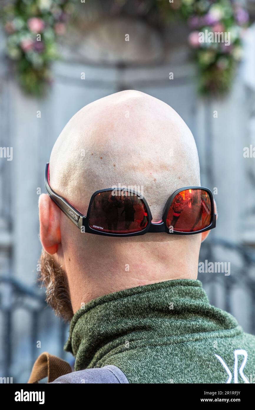Rear view of a bald head with inverted sunglasses. Brussels. Stock Photo