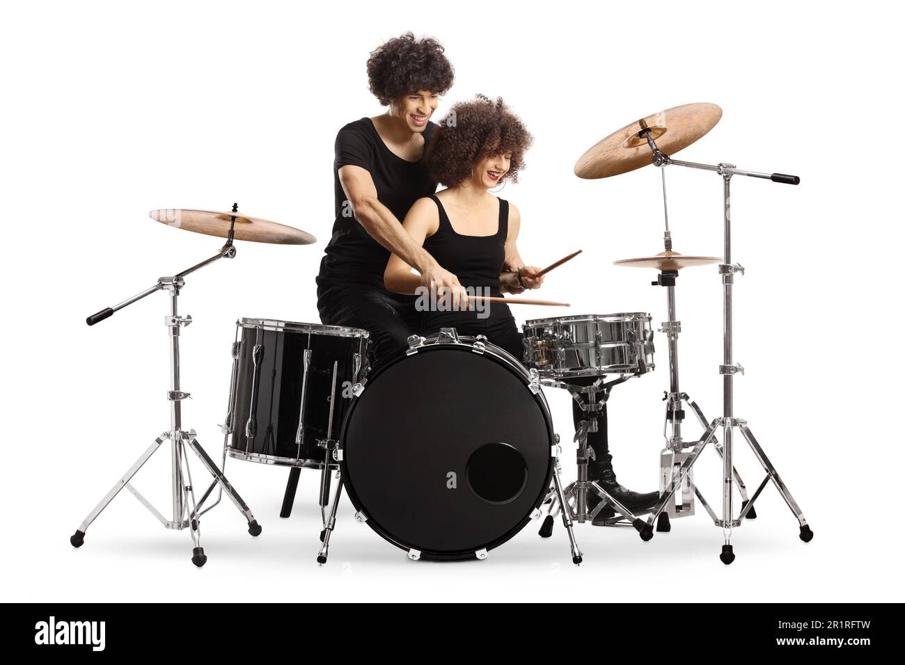 Young man teaching a woman to play drums isolated on white background Stock Photo