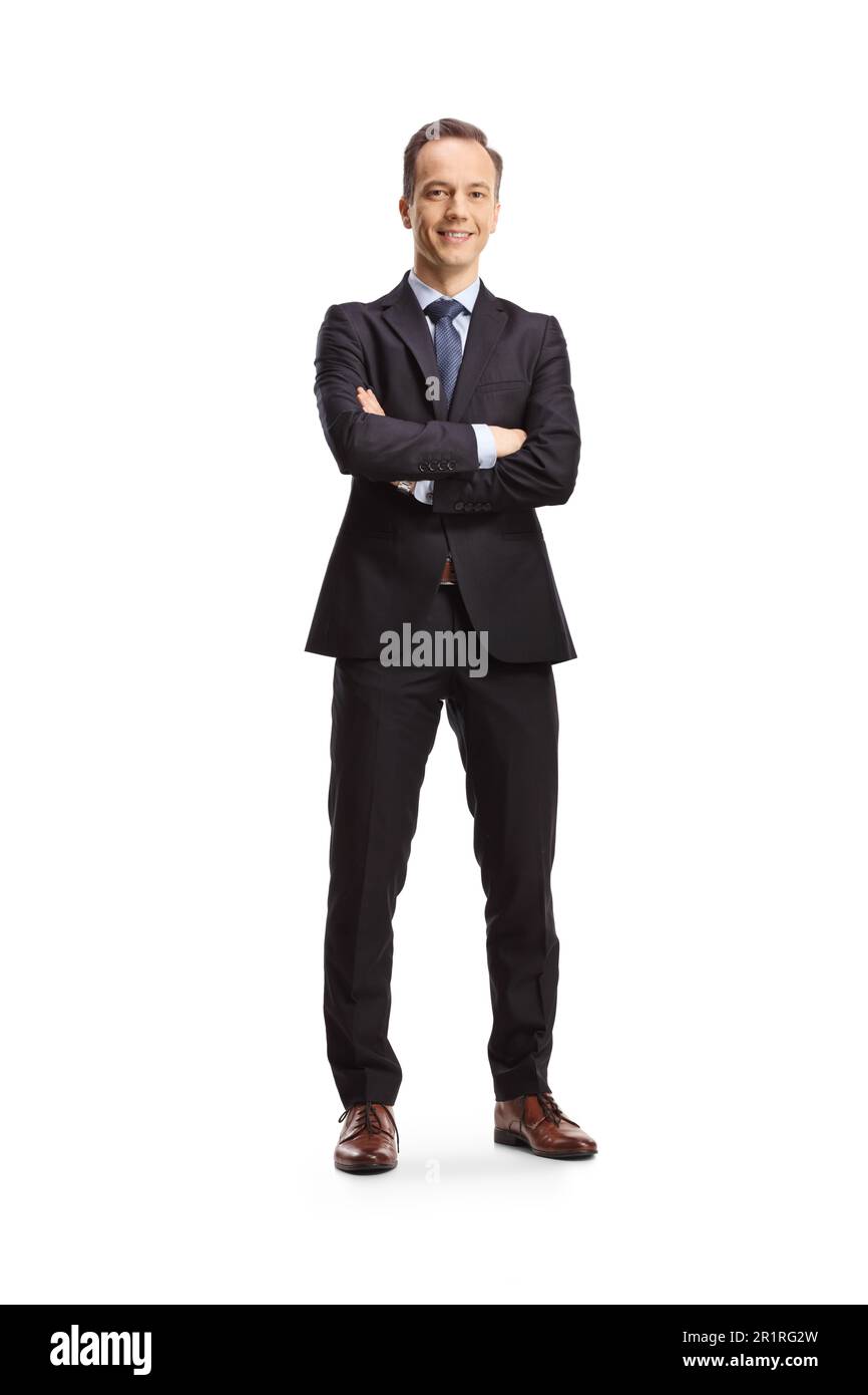 Full length portrait of a businessman standing with folded arms and ...