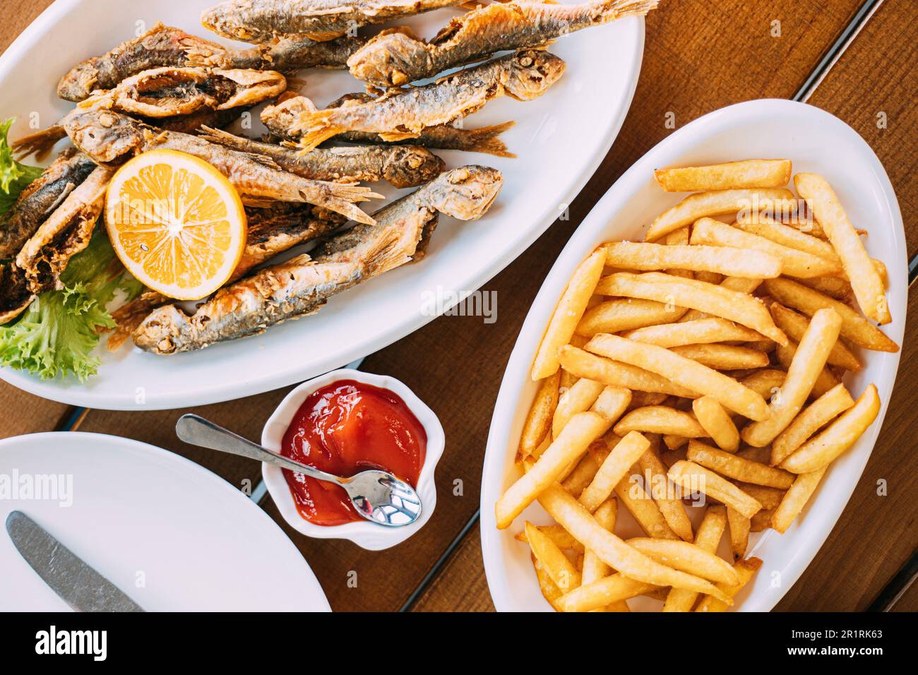 french fries and grilled fishes. fish and chips. Dish with Mullet Fish