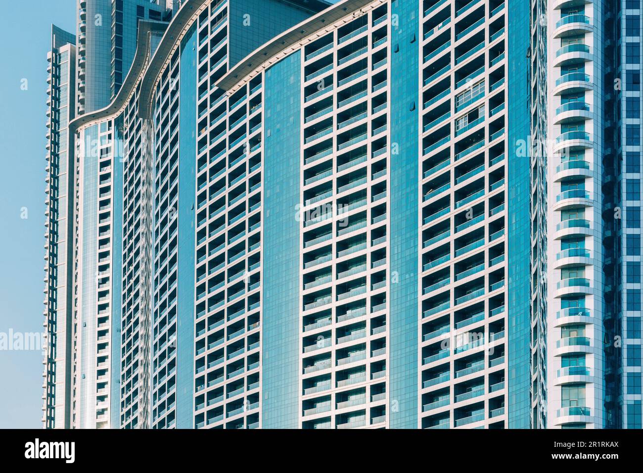 Wall With A Balcony Of New Empty Modern Multi-storey Residential Building House In Residential Area On Blue Sky. Close Up. Stock Photo