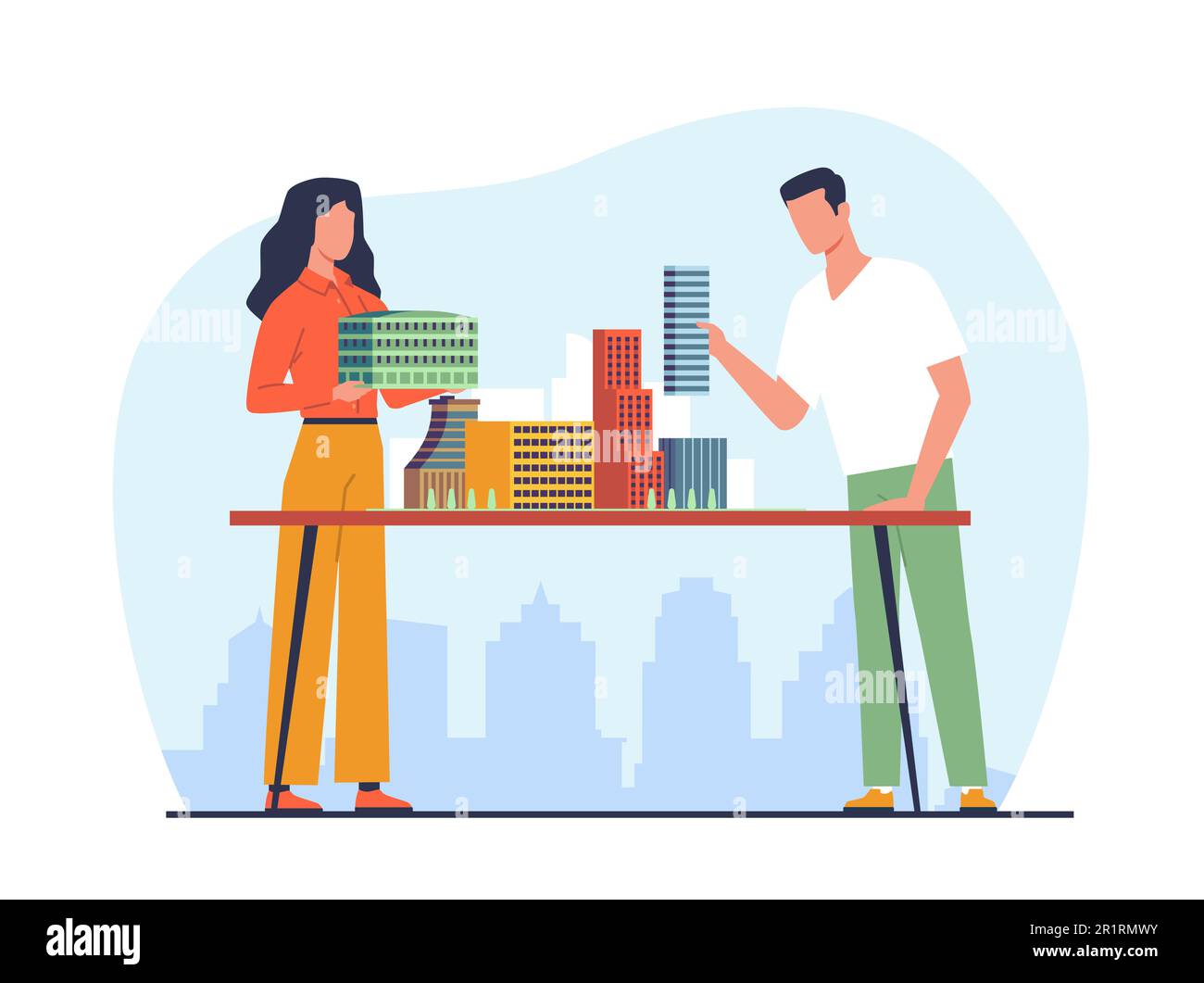 Architects man and woman build model of residential area with