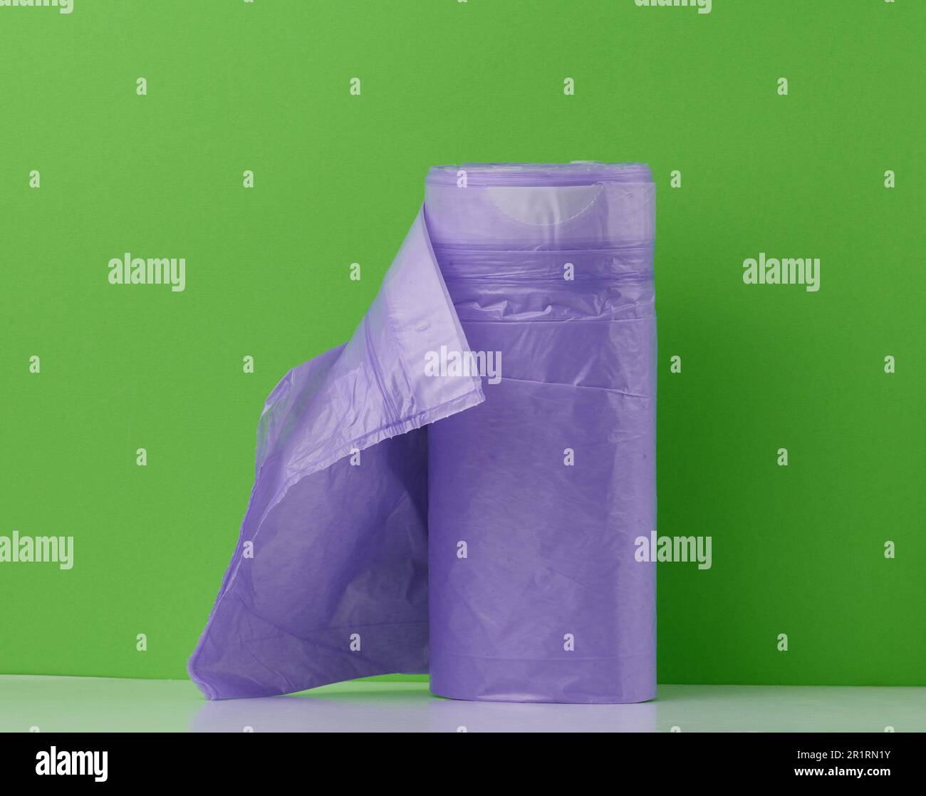 skein of purple plastic trash bags with strings isolated on white  background, close up Stock Photo - Alamy