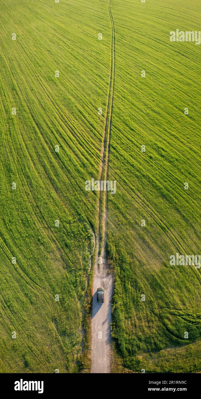 Aerial view of car SUV parked near countryside road in field rural landscape. Aerial view of car SUV parked near countryside road in summer field Stock Photo