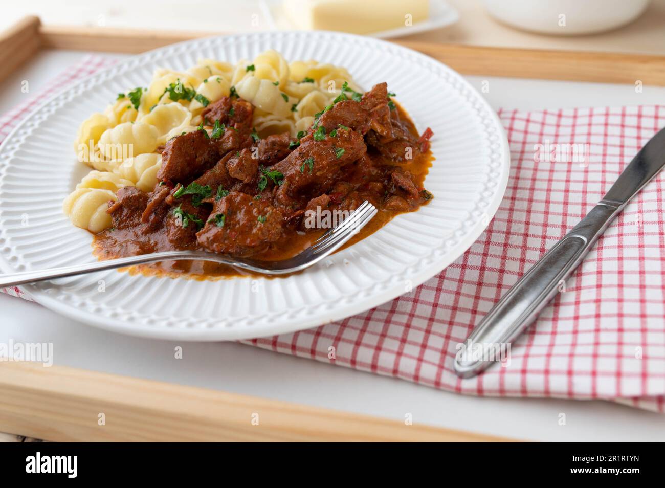 Goulash with pasta on a plate Stock Photo
