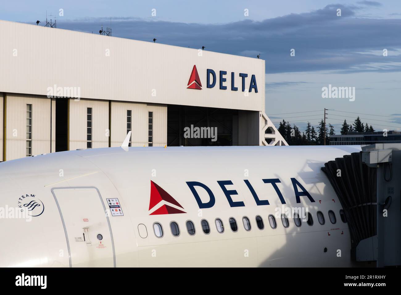 SeaTac, WA, USA - April 26, 2023; Name and logo on Delta Air Lines plane and aircraft hanger Stock Photo