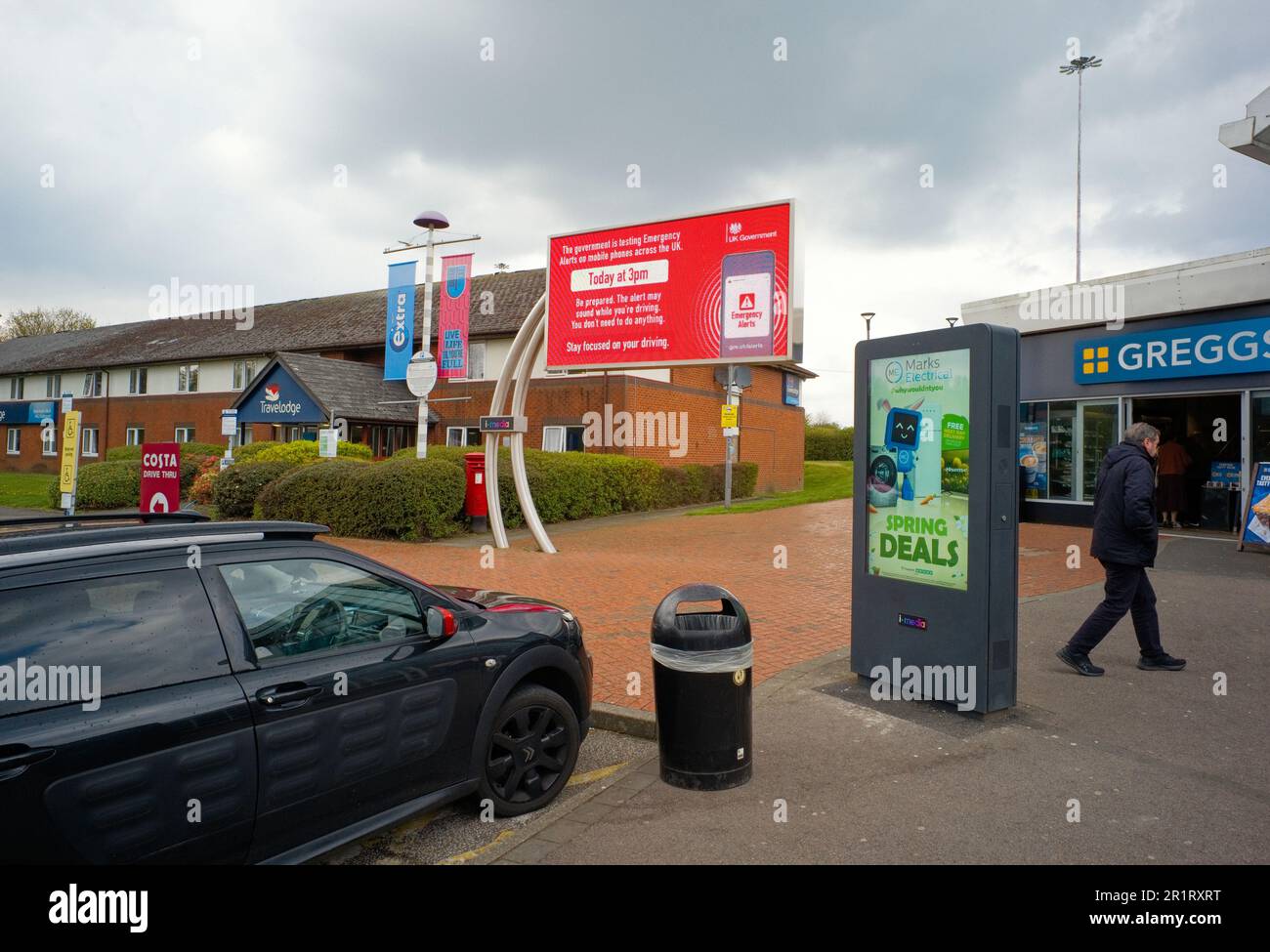 Warning signs of emergency alert test at a motorway service station