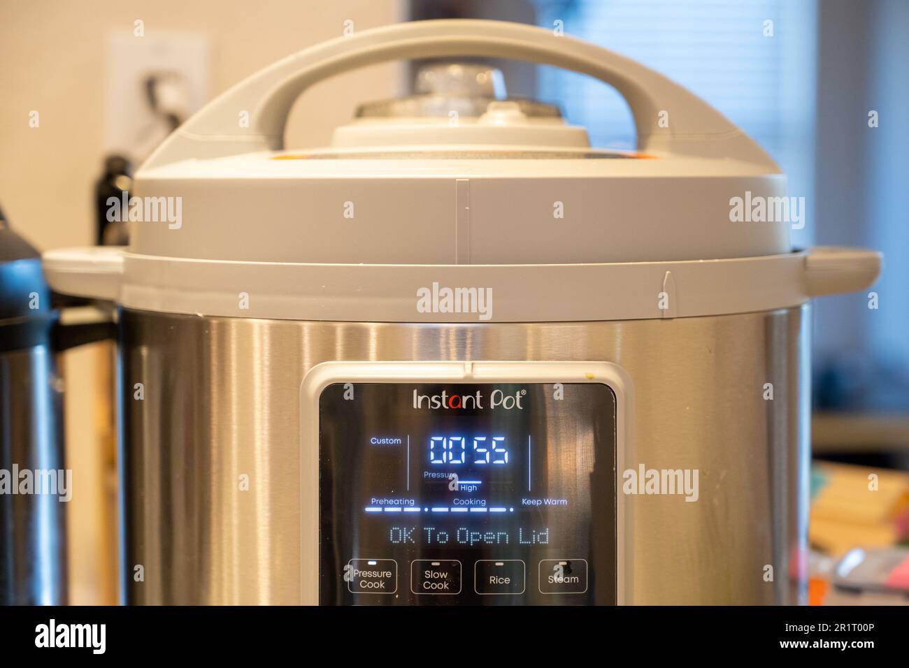 A person's hand adjusts the pressure valve on an Instant Pot pressure cooker,  Lafayette, California, February 8, 2022. Photo courtesy Sftm Stock Photo -  Alamy