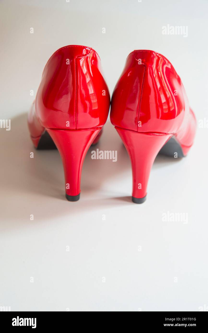 Pair of red high-heeled shoes. Stock Photo