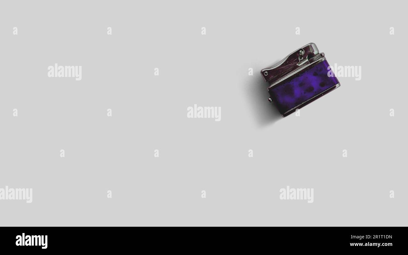 Isolated metallic lighter on grey background , added copy space for text. Stock Photo