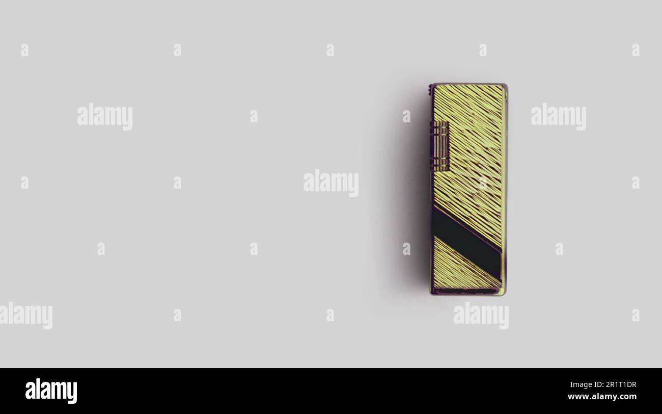 Isolated metallic lighter on grey background , added copy space for text. Stock Photo