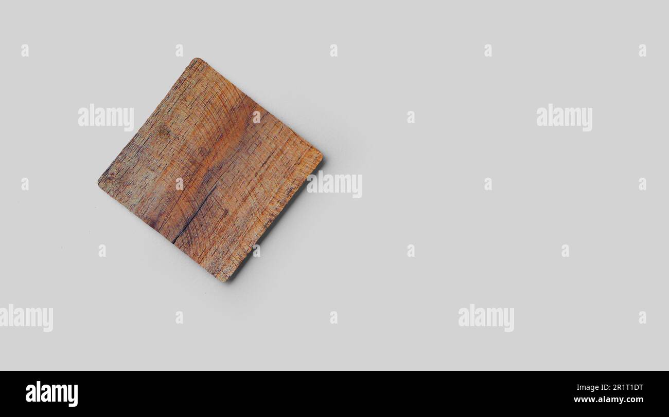 Empty square cork coaster, isolated on grey background. Perfect as food display. Stock Photo