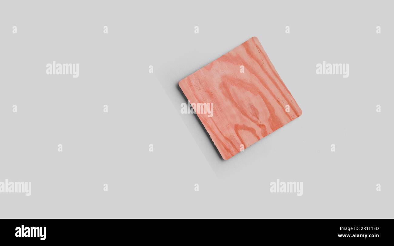 Empty square cork coaster, isolated on grey background. Perfect as food display. Stock Photo