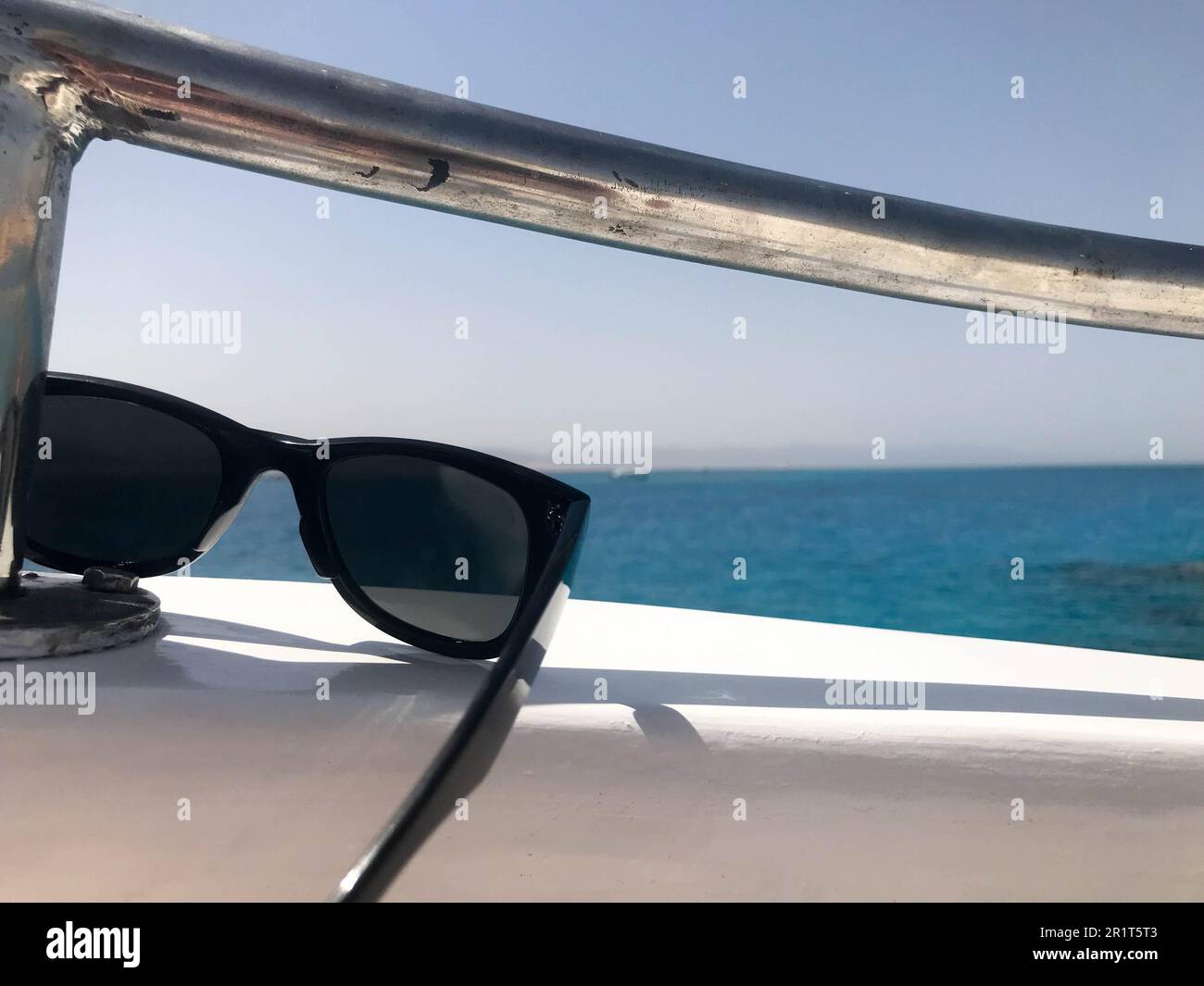 Black protective sunprotective plastic glasses hang on beryl aboard a tourist vessel, yacht and