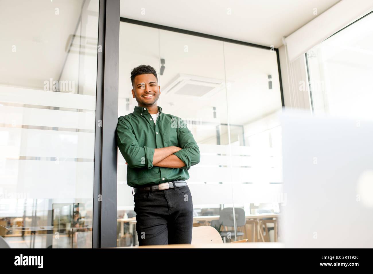 Cheerful indian modern businessman male entrepreneur standing in